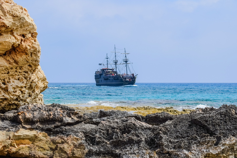 beach, sky, pirate ship, beauty in nature, day, cruise ship, solid, nautical vessel, land, landscape, rock - object, outdoors, sailboat, passenger craft
