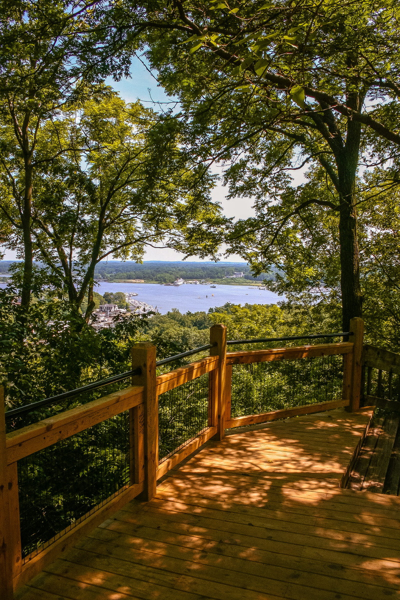 michigan, land, tranquil scene, river, sunlight, beauty in nature, park, railing, plant, deck, tree, architecture, green color, growth, united states, built structure