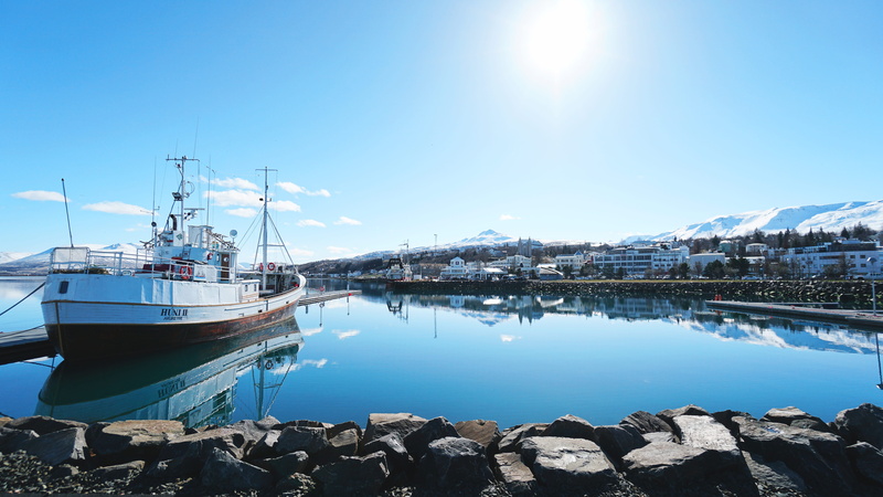 no people, sky, town, snow, deck, moored, harbor, sunny, float, reflection, view, mode of transportation, mirrored, water, sun, outdoors, flare, nautical vessel