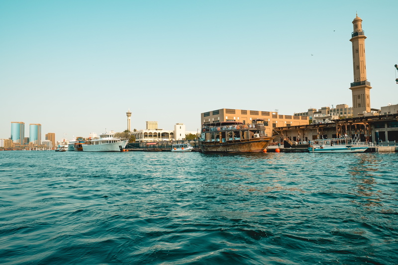 rippled, historically, water, mode of transportation, dubai, cityscape, sky, frame, office building exterior, canal, outdoors, transportation, dhow, ship
