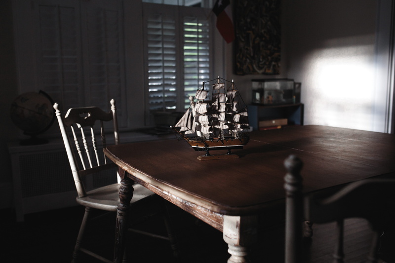 window, still life, seat, nautical, sunlight, dark, room, empty, arrangement, shutter, interior, glass - material, shadow, table, reflecting, sailing boat