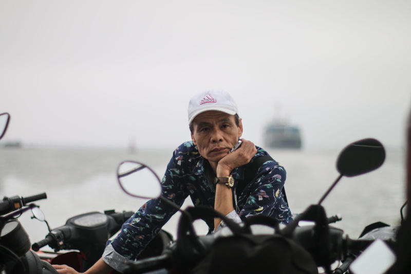 cat ba, holding, day, front view, one person, nature, mode of transportation, land vehicle, adidas, vietnam, motorbike, bicycle, ferry, outdoors, mature adult