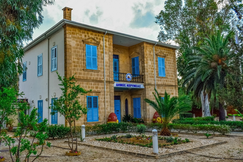communication, cyprus, building, palm tree, building exterior, city, tropical climate, sign, kyrenia city hall, sky, built structure, residential district