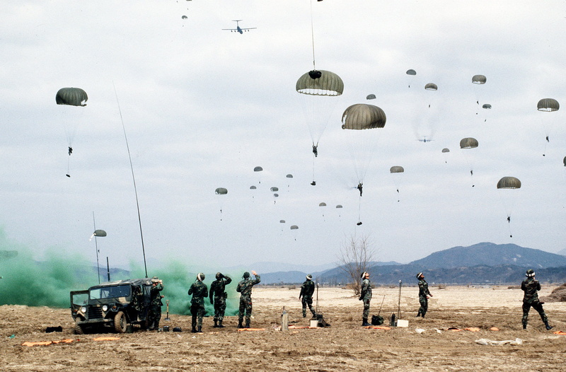 sky, near, military, war, water, stands, adult, crowd, parachute, field, person, real people, defense, government, sport, transportation, large group of animals