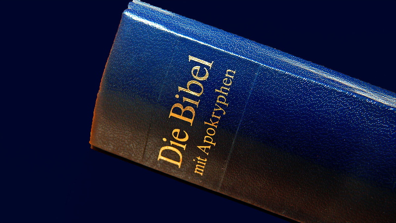 communication, Bible, wealth, single object, black background, faith, studio shot, indoors, bag, religion, high angle view, blue background, close-up, christ