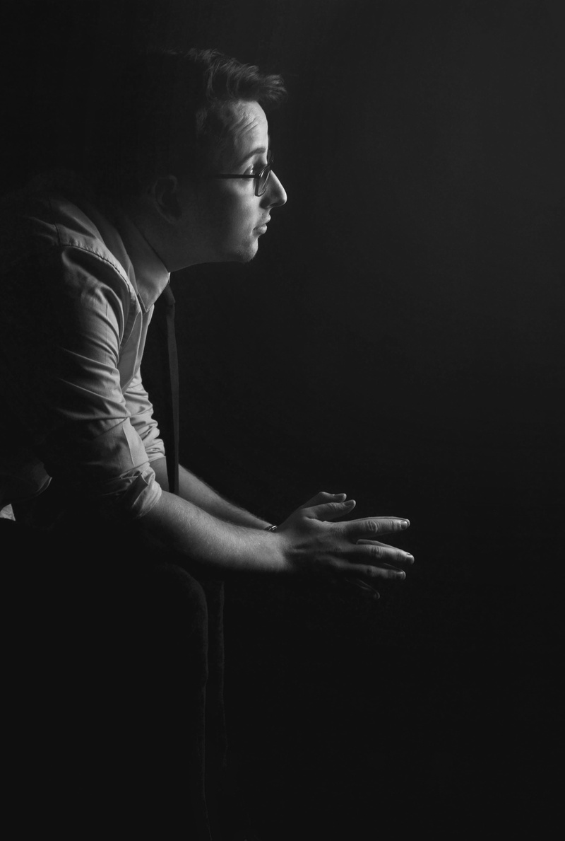 indoors, real people, profile view, young adult, greyscale, think, young men, contemplation, looking away, entreaty, adult, photography, looking, three quarter length