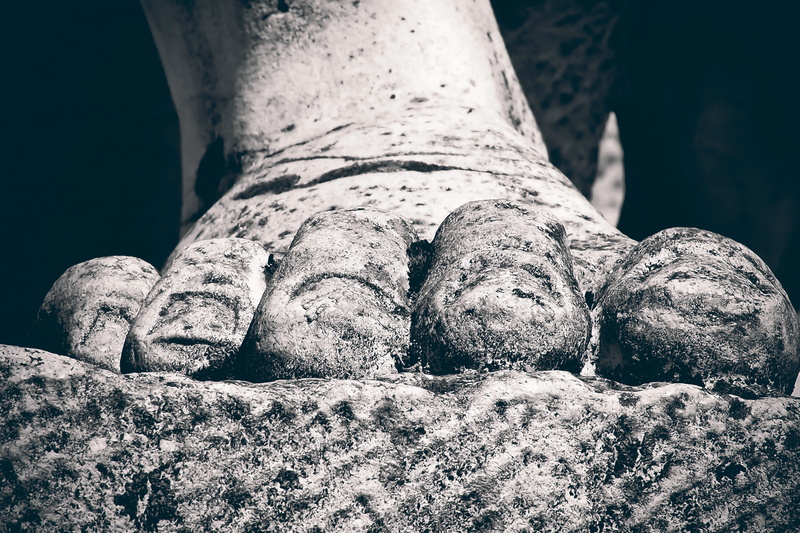 person, body part, focus on foreground, tombstone, close up, close, nature, foot, figure, tomb, low section, mystical, rest, grave, day, art, adult, rock - object