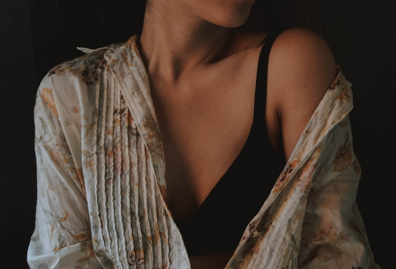 long sleeve, face, human, wearing, sleeve, black, couch, beauty, top, beautiful woman, young women, black background, sleeved, apparel, darkness, female