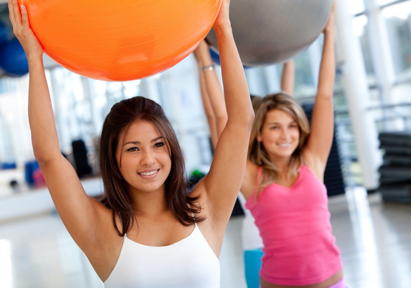 lifestyles, smiling, young adult, cheerful, training, ball women, 5K, gym balls, gym, young women, human limb, happiness, emotion, arms raised, human arm