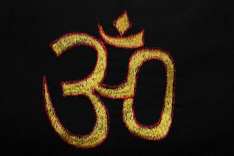 text, celebration, spirituality, Black, no people, Yellow, black background, close-up, wealth, sign, buddhism, luxury, black, Om, hinduism, aum, group of objects