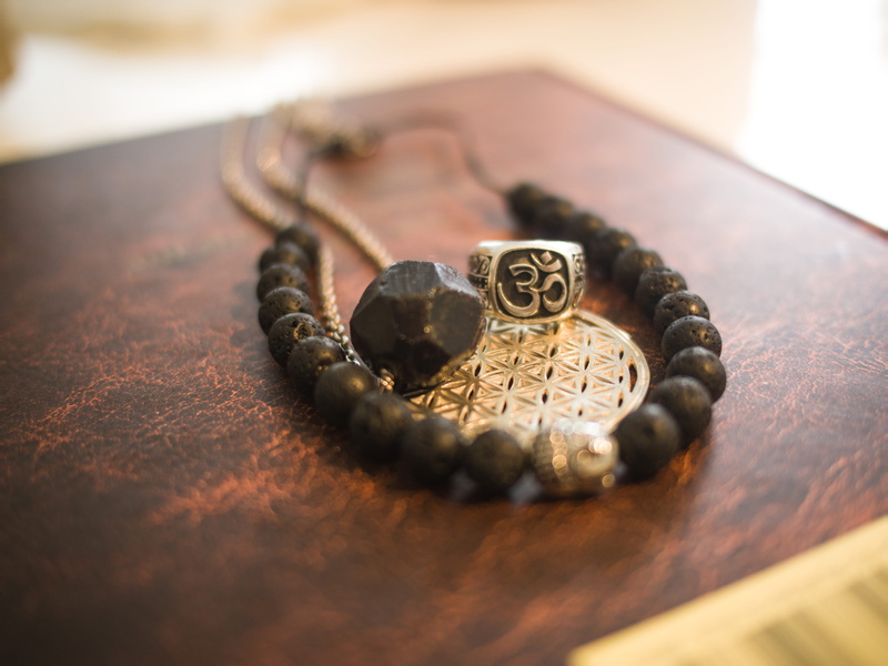table, jewelry, spirit, history, metal, personal accessory, indoors, rubin, spiritual, watch, om, flower of life, mode, no people, old, day, ornate, book