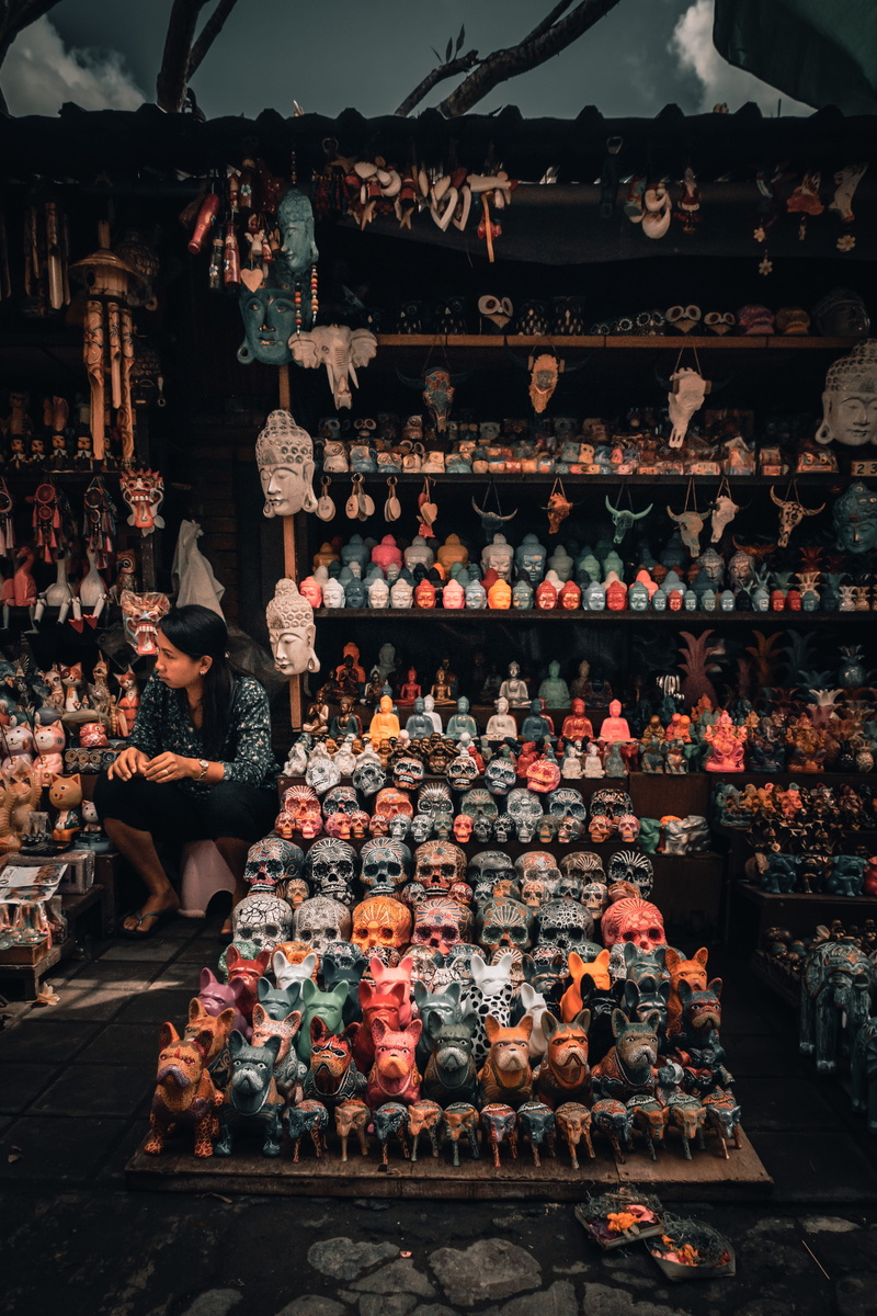 woman, shelf, sits, sale, large group of objects, beside, architecture, in a row, market, 5K, still life, display, abundance, business, stack, food, retail display