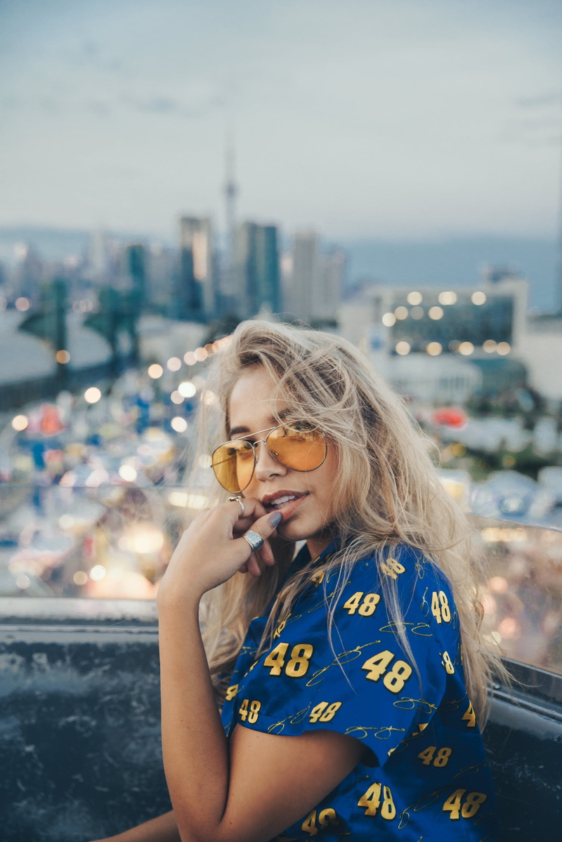 carnival, Hair, woman, young, lifestyles, portrait, city, building exterior, built structure, leisure activity, Women, sunglasses, focus on foreground