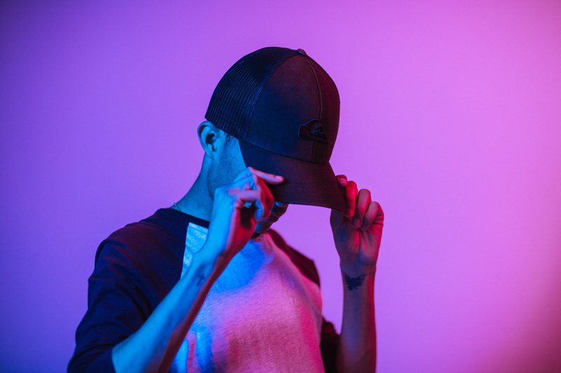 man, waist up, clothing, person, hat, headshot, wearing, colored background, good-looking, attractive, cap, 5K, purple, posing, portrait, glamour, pink color