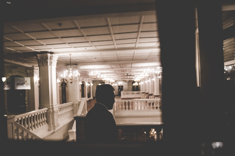 floor, indoors, photo, moody, black suit, building, illuminated, higher, one person, real people, frame, sitting, women, balcony, inside, restaurant, built structure