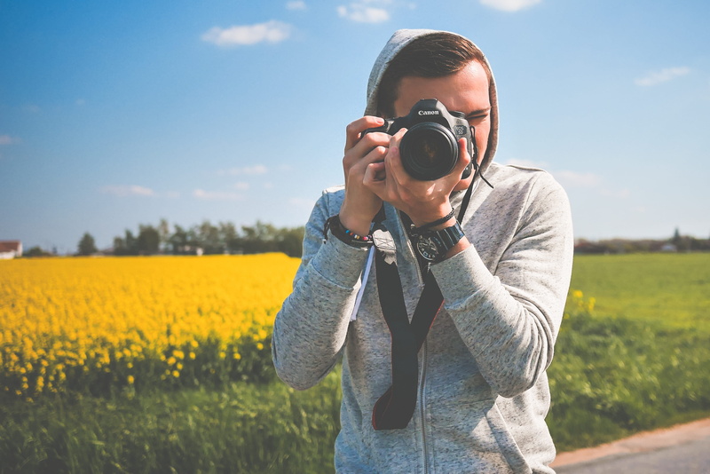 dslr, holding, standing, photography, canon, 2K, real people, working, activity, people, work, waist up, casual clothing, taking, photographic equipment