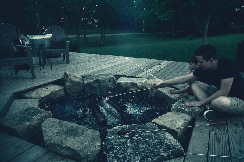community, smoores, real people, fire, side view, rocks, barbecue, white house, males, outside, lifestyles, marshmellows, seat, outdoors, 2K, sitting