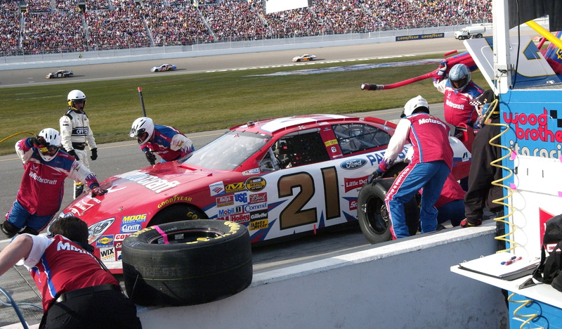 track and field, headwear, sports equipment, helmet, sports race, team, nascar, group of people, men, athlete, race, sportsman, stop, stadium, sports helmet