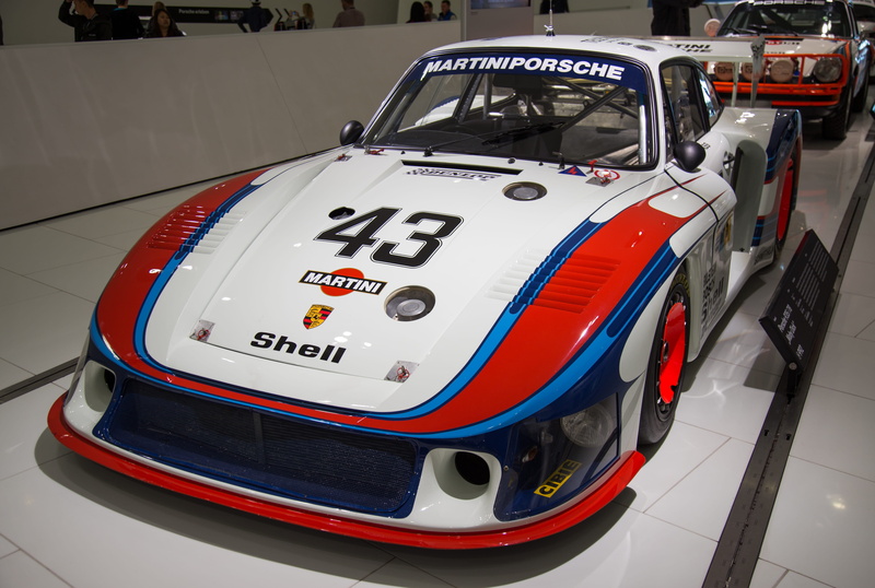 day, car, human, windshield, race car, stationary, number, automobile, car show, wheel, airliner, vehicle, machine, focus on foreground, sports car, pit stop