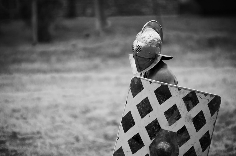 shield, monochrome, human body part, helmet, day, grayscale, childhood, focus on foreground, nature, hat, gladiators, man, field, shoe, obscured face, relaxation