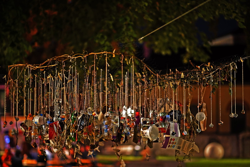 plant, plastic, chur, group of people, sky, focus on foreground, hanging, crowd, arts culture and entertainment, large group of people, amusement park