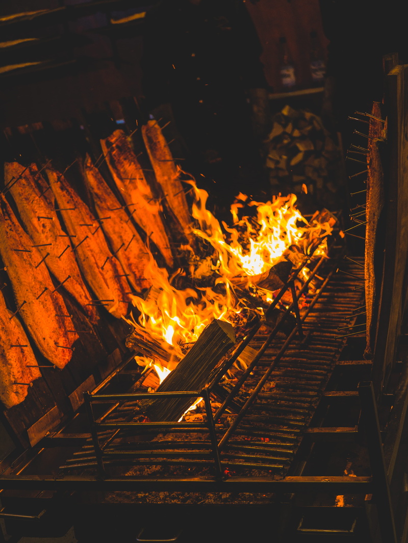 log, cornbread, built structure, fire, fire - natural phenomenon, bbq, orange color, handrail, grill, outdoors, glowing, forge, wood, firewood, banister