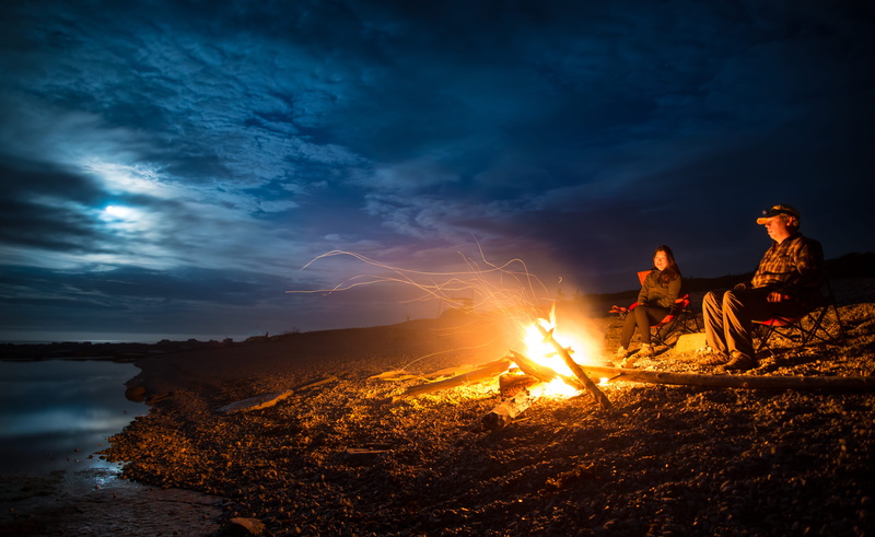 bonfire, fire, land, sitting, havre-saint-pierre, shore, seashore, outdoors, man, dusk, coast, fire - natural phenomenon, cloud - sky, leisure activity