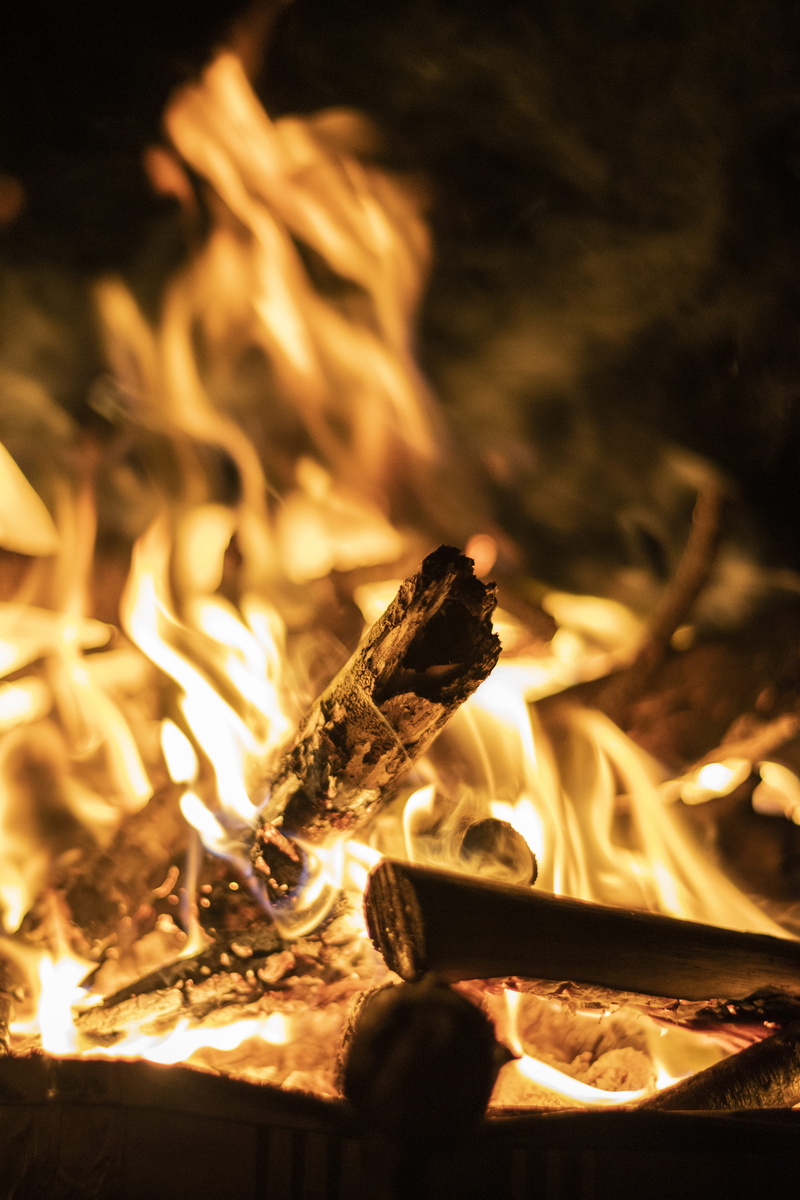 outdoors, fireplace, glass, orange color, eruption, bonfire, glowing, firewood, person, goblet, night, macro, flame, log, woven, mountain, human, lava