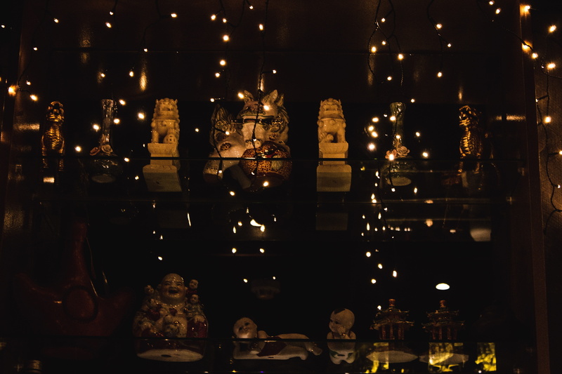 arcade game machine, decoration, religion, low angle view, amusement park, vigil, human representation, fire, lifestyles, treasure, electric lamp, dark