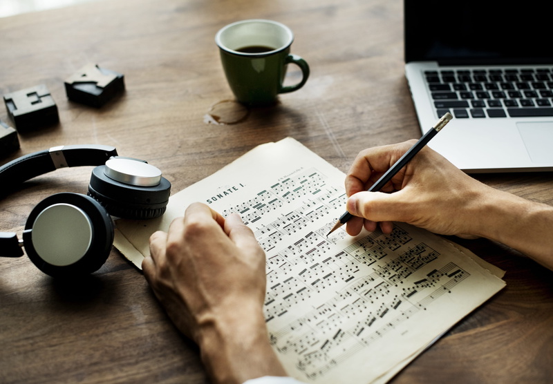 hand, background, pen, mug, person, pencil, cup, indoors, leaning, coffee, finger, holding, one person, sheet, earphones, coffee - drink, table, screen
