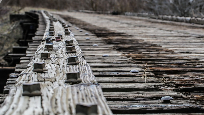 bridge, high angle view, outdoors, architecture, focus on foreground, low saturation, still life, land, nature, pattern, close-up, rivets, selective focus