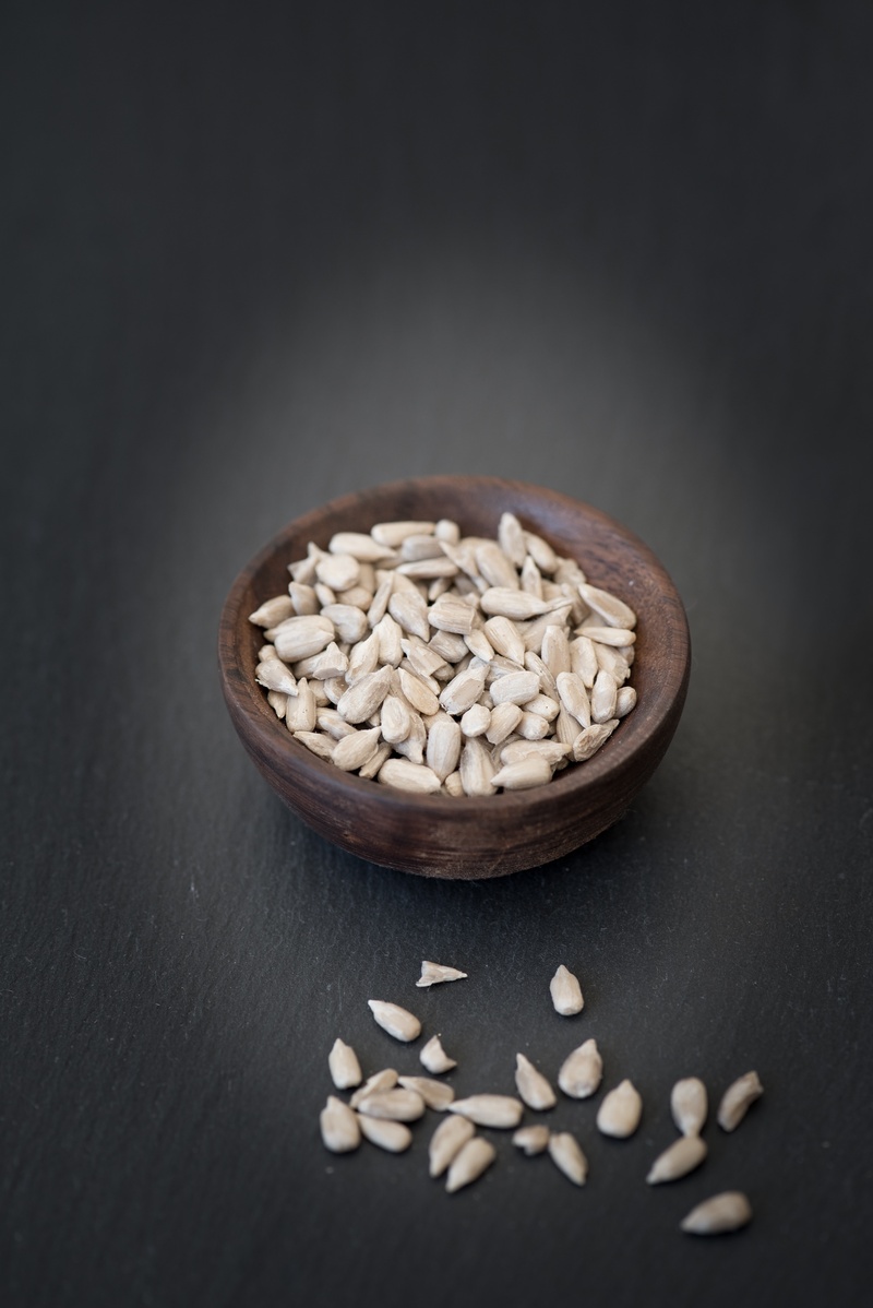 sunflower seeds, black background, healthy eating, shelled sunflower seeds, food, close-up, gray background, seed, text dom, eat, cores, wellbeing, raw food