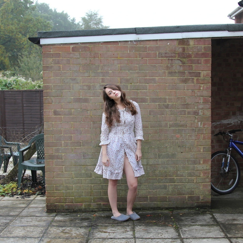 full length, Imogen Dyer, real people, fashion, one person, long hair, lifestyles, wall, standing, hair in face, women outdoors, leisure activity, day
