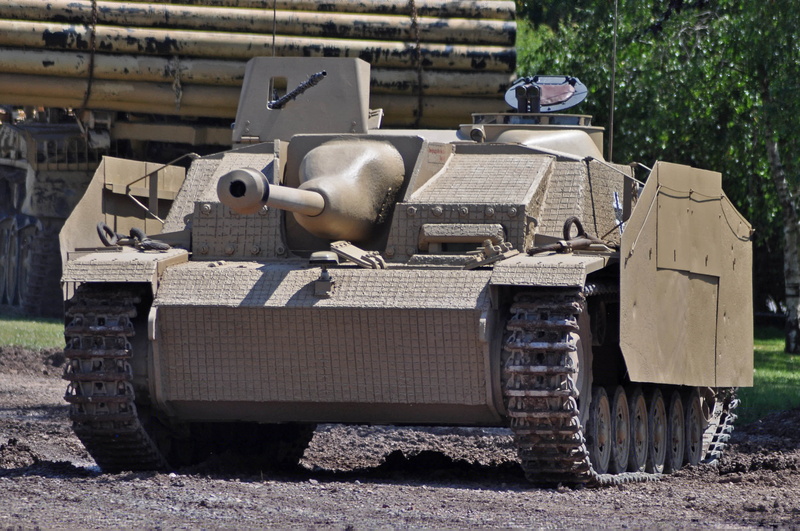 transportation, StuG III, outdoors, Second, self-propelled, installation, 2K, German, focus on foreground, land, rail transportation, tree, old, metal