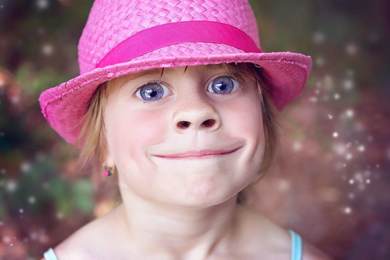 looking at camera, day, innocence, close-up, smiling, Face, front view, wearing, Comic, Hat, eye, troll, focus on foreground, body part, portrait, emotion