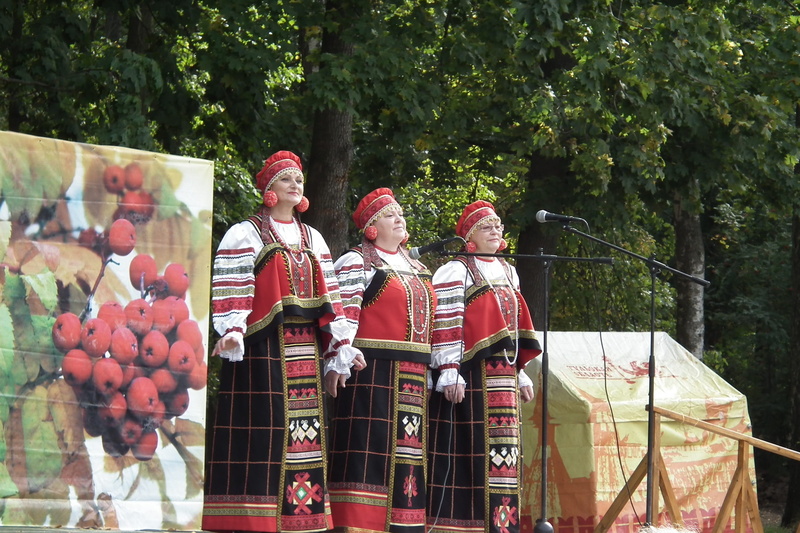 traditional clothing, arts culture and entertainment, outdoors, holding, plant, day, men, song, choir, nature, sundress, adult, tradition, people, russians