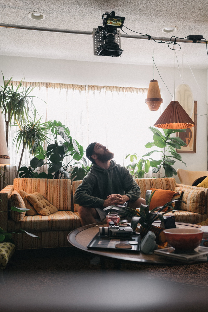 young men, sofa, men, 8K, furniture, young adult, electric lamp, males, one person, potted plant, lifestyles, window, man, leisure activity, mid adult