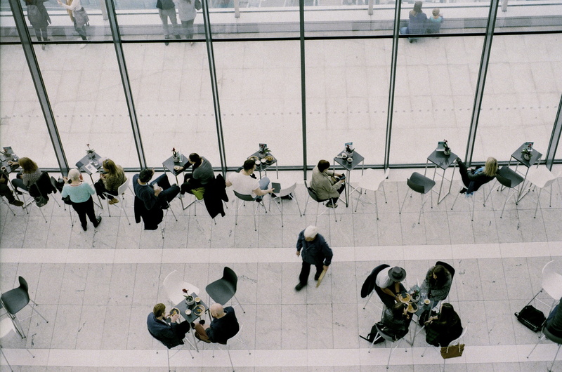 breakfast, person, travel, network, sitting, man, tiled floor, public, adult, large group of people, cafe, full length, crowd, window, flooring, eating