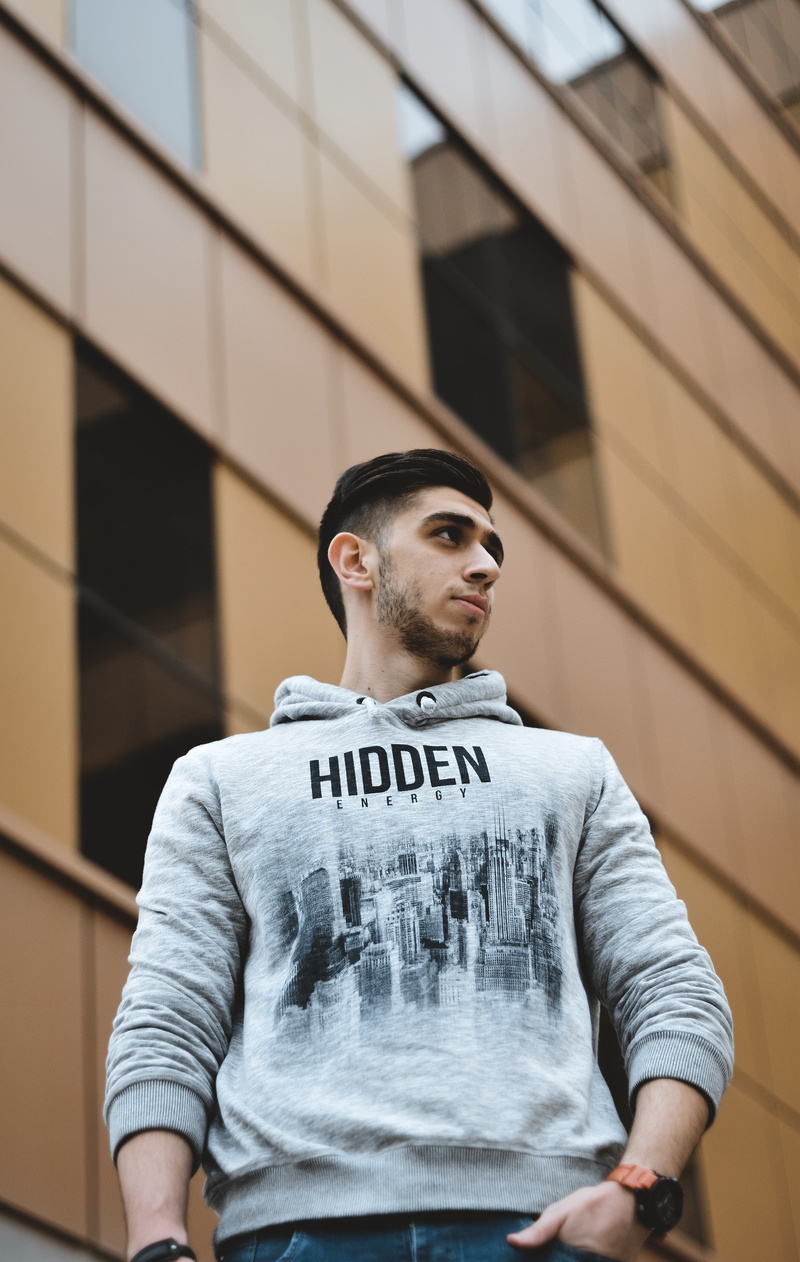 sweater, hooded, front view, 5K, handrail, day, clothing, photo, beard, sleeve, standing, building exterior, building, young men, casual clothing, hood