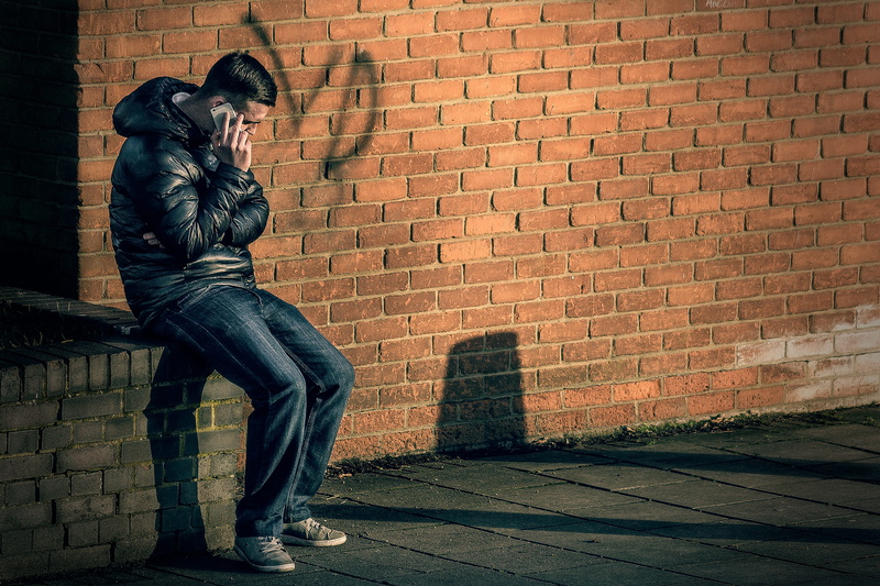 sitting, representation, black, smartphone, building, full length, jacket, street, man, no people, human representation, 5K, outdoors, person, holding