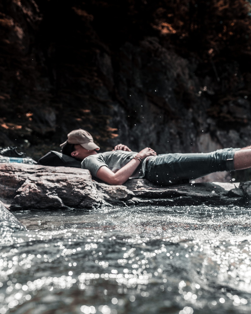selective focus, falls, young women, forest, water, lifestyles, women, rock, chill, 2K, young adult, male, full length, nature, real people, travel, outdoors