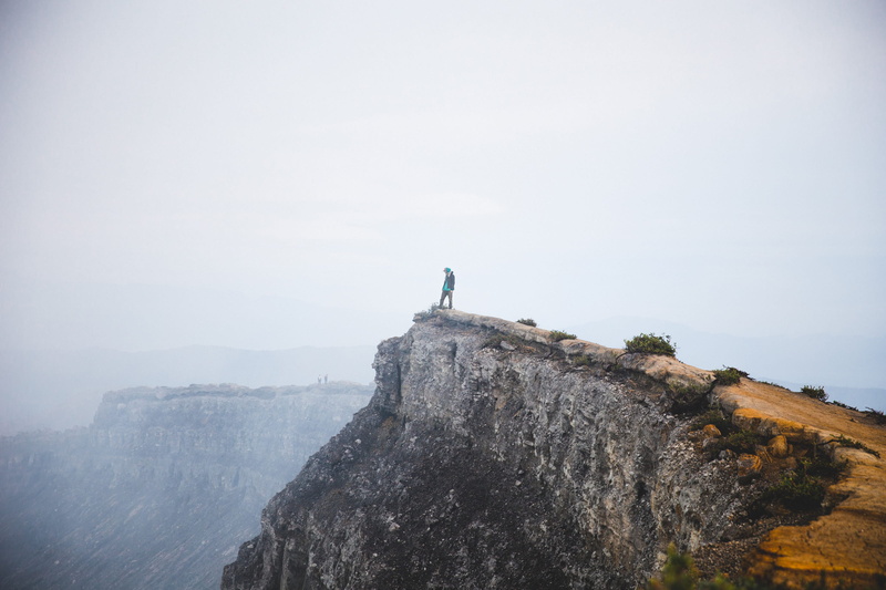 peaks, rock - object, risk, beauty in nature, adventure, foggy, adult, 25-30 year old, area, hiker, fog, edge, mountain, mountains, young, journey, building exterior