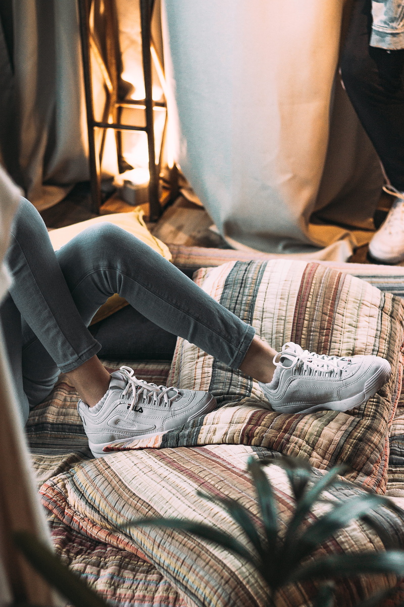 jeans, furniture, body part, person, human body part, clothing, human foot, room, commerce, light, sneakers, wear, fila, home, human leg, low section, comfortable