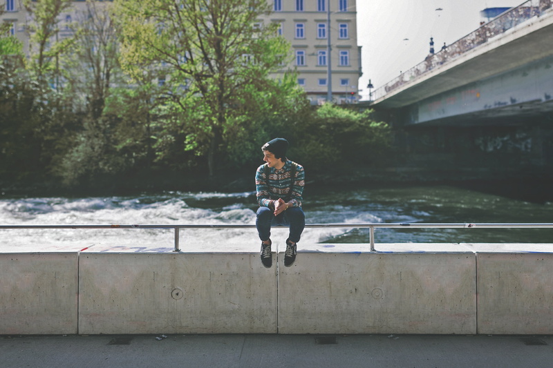 city, tree, nature, outdoors, smiling, metal, jeans, building exterior, boy, trees, sitting, rails, connection, smile, guy, student, architecture, retaining wall