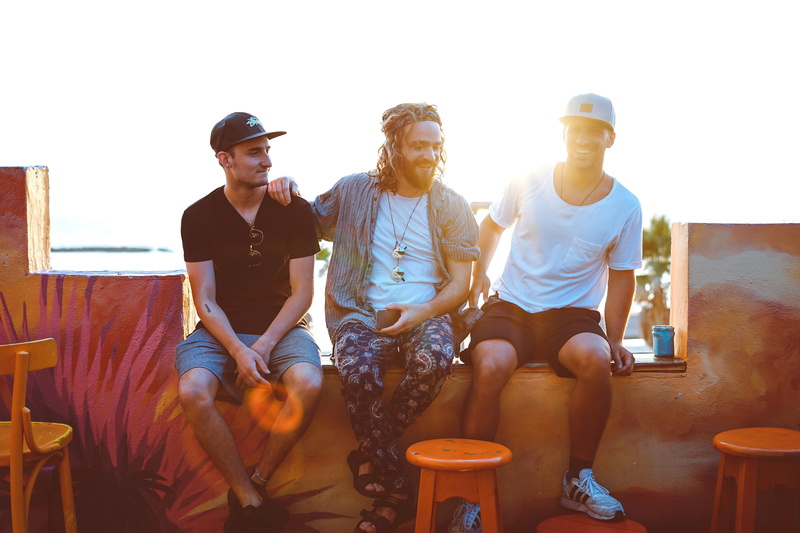 friends, three, rooftop, friendship, facial expression, togetherness, happiness, leisure, sitting, sundown, sky, people, orange, male, indoors, casual clothing