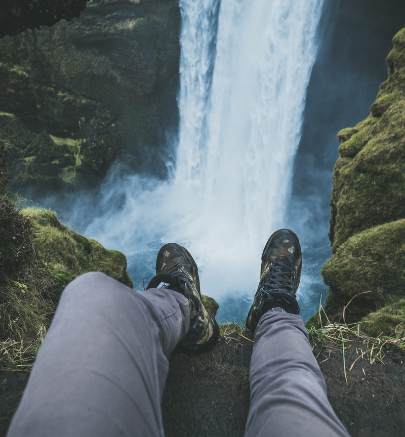 cliff, drop, leisure activity, human body part, ledge, skogafoss, shoe, water, beauty in nature, human leg, dreamevile, waterfall, real people, skógafoss
