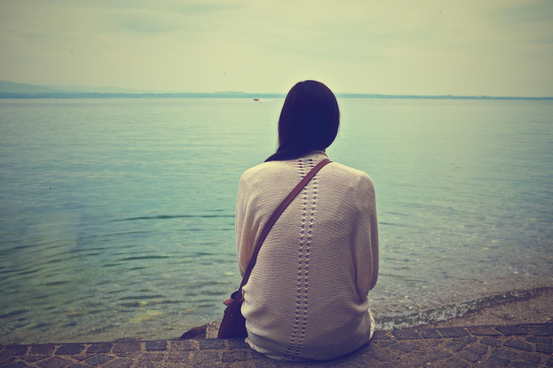 one person, shirt, sky, daytime, water, sitting, woman, sleeve, rear view, pavement, horizon, brunette, scenics - nature, women, leisure activity, brown