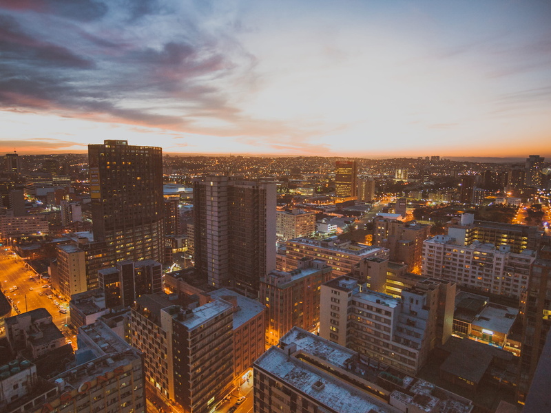 crowd, building exterior, orange color, beach, skyscraper, city, pink, cloud - sky, africa, buildings, south africa, high angle view, business, sunset