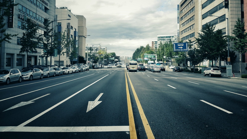 city street, motor vehicle, Seoul, built structure, city, dividing line, marking, silver, sign, direction, land vehicle, office building exterior, arrow symbol