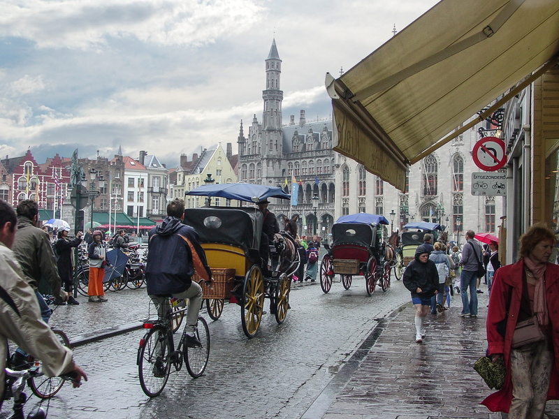 real people, medieval, europe, gothic, building exterior, man, women, transportation, riding, bicycle, day, city, building, built structure, carriage, group of people